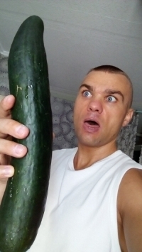 A man with a huge cucumber